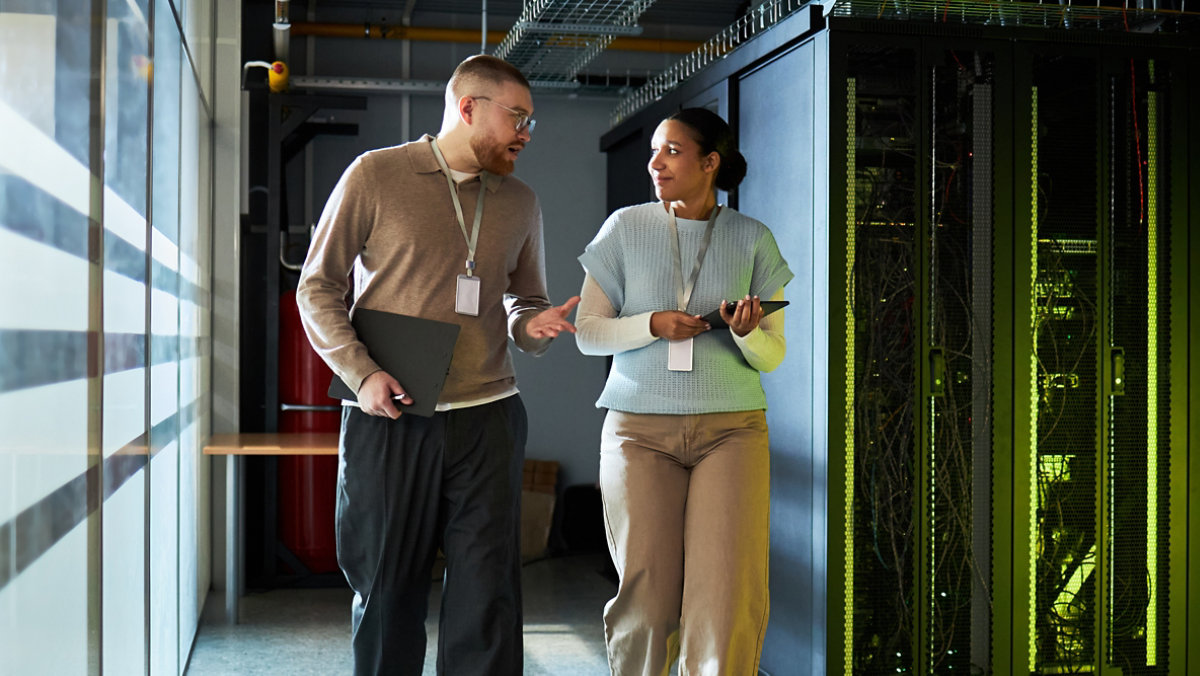 man and woman walking through server room