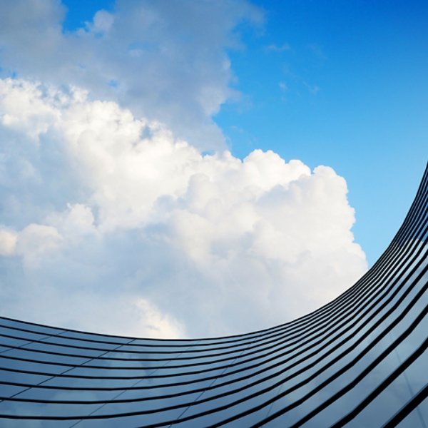 Perspective of high rise building and dark steel window system with clouds reflected on the glass.Business concept of future architecture,lookup to the angle of the building corner. 3d rendering