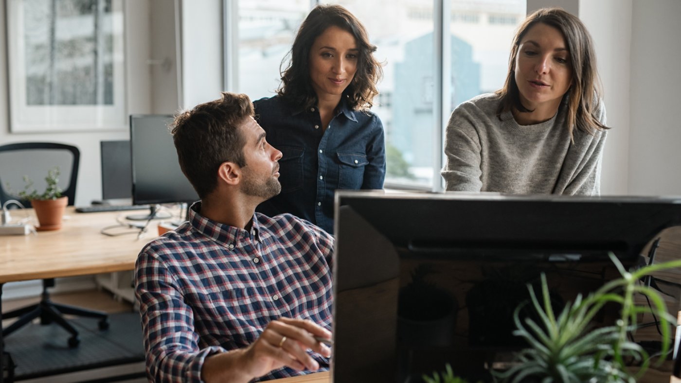 Group of diverse young designers working together on a computer