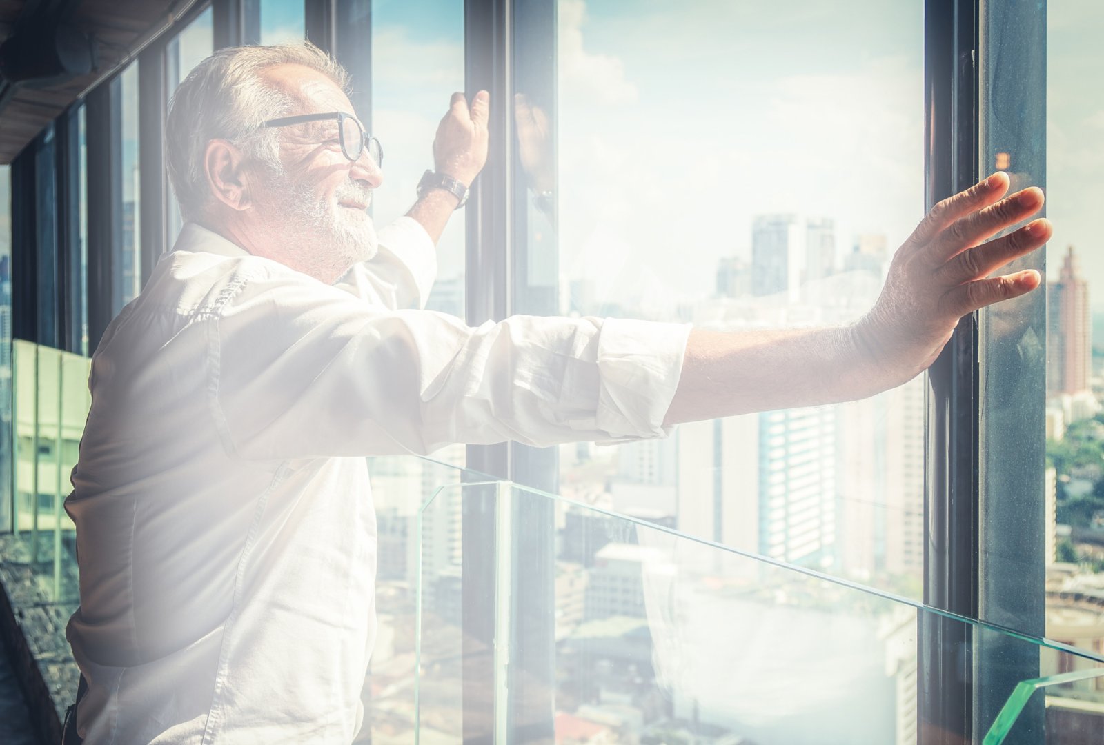 portrait of senior businessman with beard and glasses feeling confident standing in executive room in business building