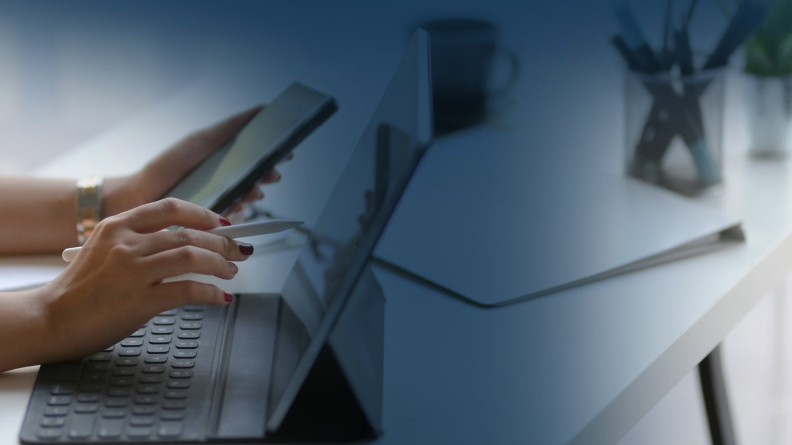 Side view of female entrepreneur focusing on her work with mock-up tablet  on white table