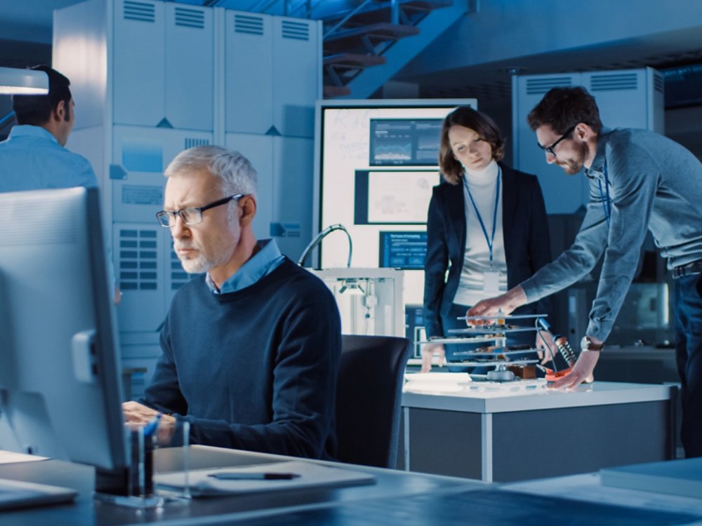 Diverse International Team of Industrial Engineers and Scientists Working in Research Laboratory and Development Center. People Working with 3D Printing, Using Computers, Designing Hardware