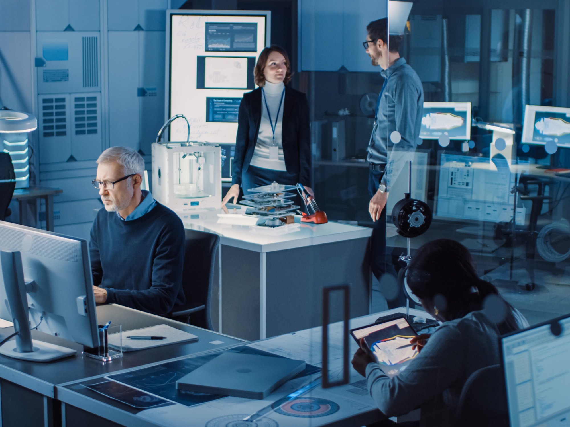 Diverse International Team of Industrial Engineers and Scientists Working in Research Laboratory / Development Center. People Working on Efficient Engine Design, Using Computers, Advanced Technology