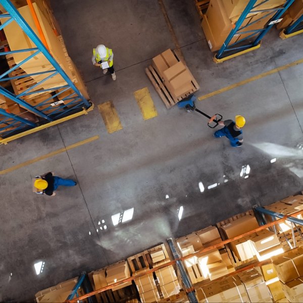 Top-Down View: In Warehouse People Working, Forklift Truck Operator Lifts Pallet with Cardboard Box. Logistics, Distribution Center with Products Ready for Global Shipment, Customer Delivery