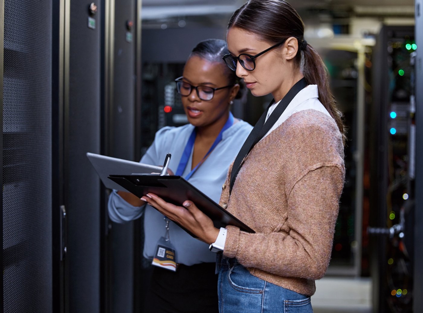 Cropped shot of two attractive young female computer programmers working together in a server room.