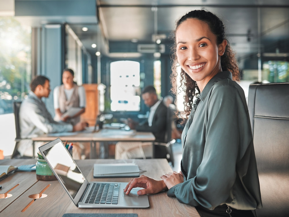 Happy entrepreneur, professional and smile business woman planning on laptop for career success, motivation and startup growth. Portrait of confident, empowered and positive young worker in an agency.