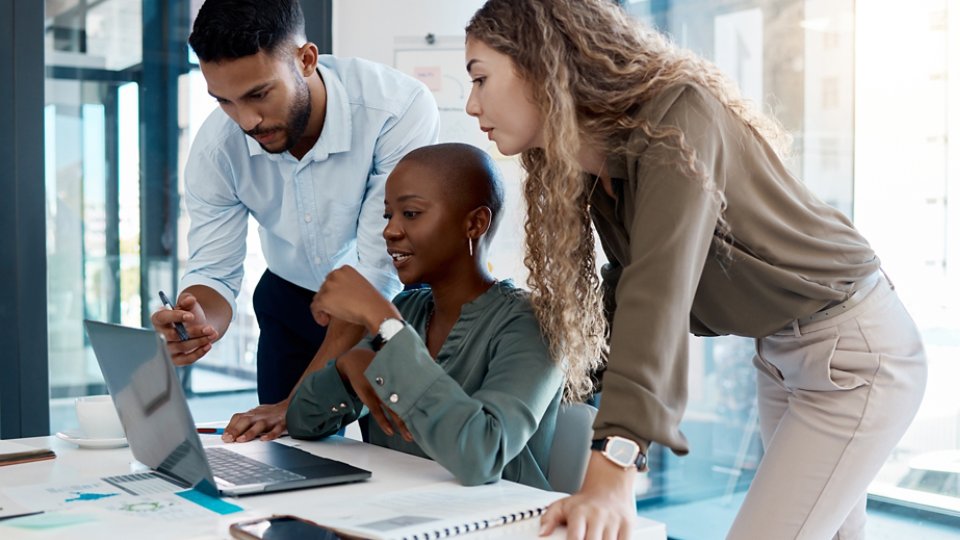 Team collaboration, online marketing and laptop planning for ideas, inspiration and strategy in startup company. Business people in diversity group working, meeting and discussion with internet tech