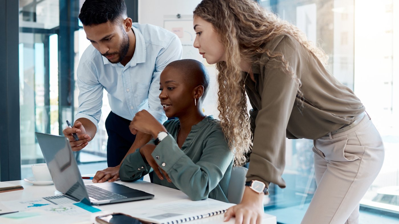 Team collaboration, online marketing and laptop planning for ideas, inspiration and strategy in startup company. Business people in diversity group working, meeting and discussion with internet tech