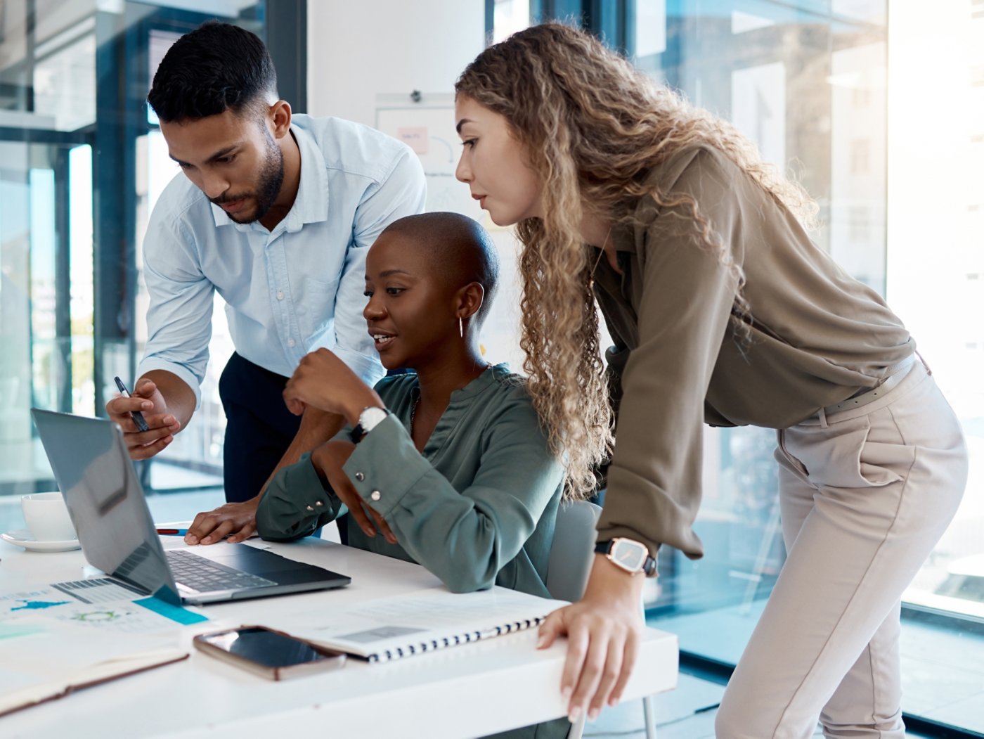 Team collaboration, online marketing and laptop planning for ideas, inspiration and strategy in startup company. Business people in diversity group working, meeting and discussion with internet tech
