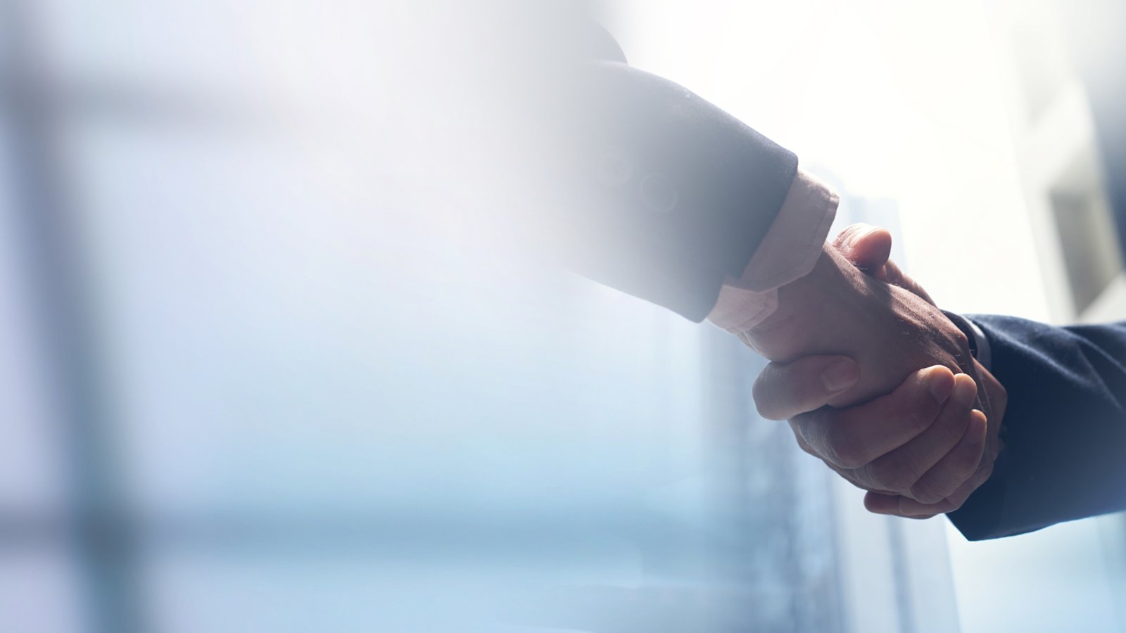 Businessmen making handshake with partner, greeting, dealing, merger and acquisition, business cooperation concept, panoramic banner, copy space for business, finance and investment background