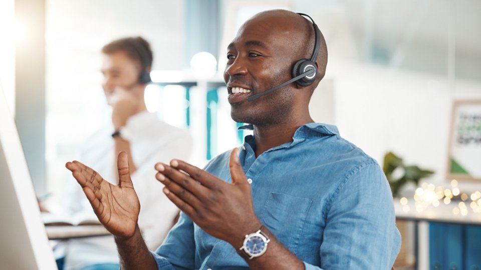 Call center, telemarketing and customer service with a business man working in an office and consulting on a headset. Help, crm and contact us with a black male consult at work on a computer.