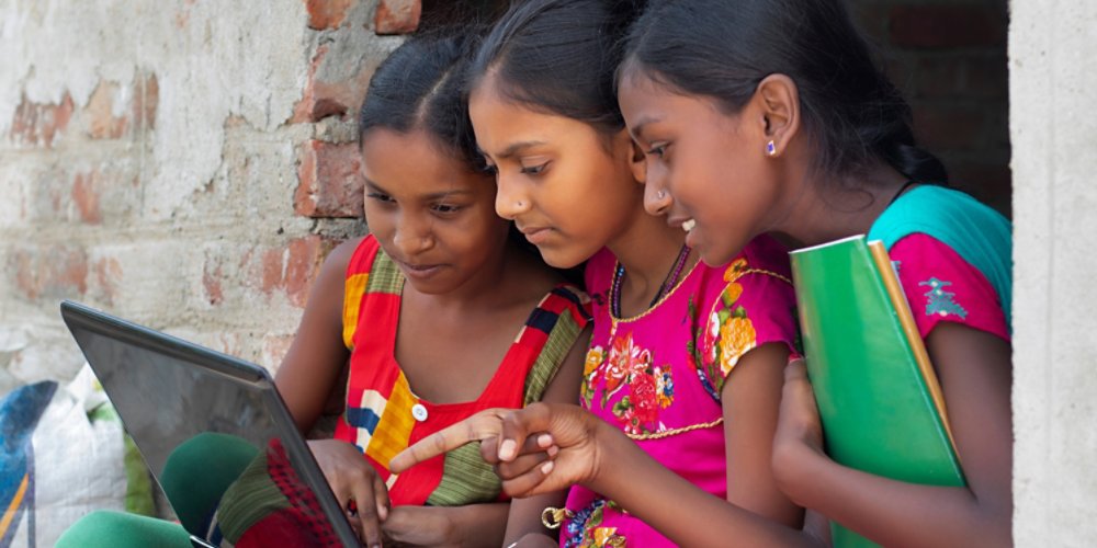 School Students Girls using laptop while studying at home