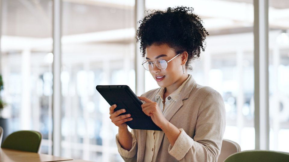 Tablet, black woman and business marketing, social media update or networking with smile. Website, company blog or online communication, office worker with glasses smile for digital strategy success.