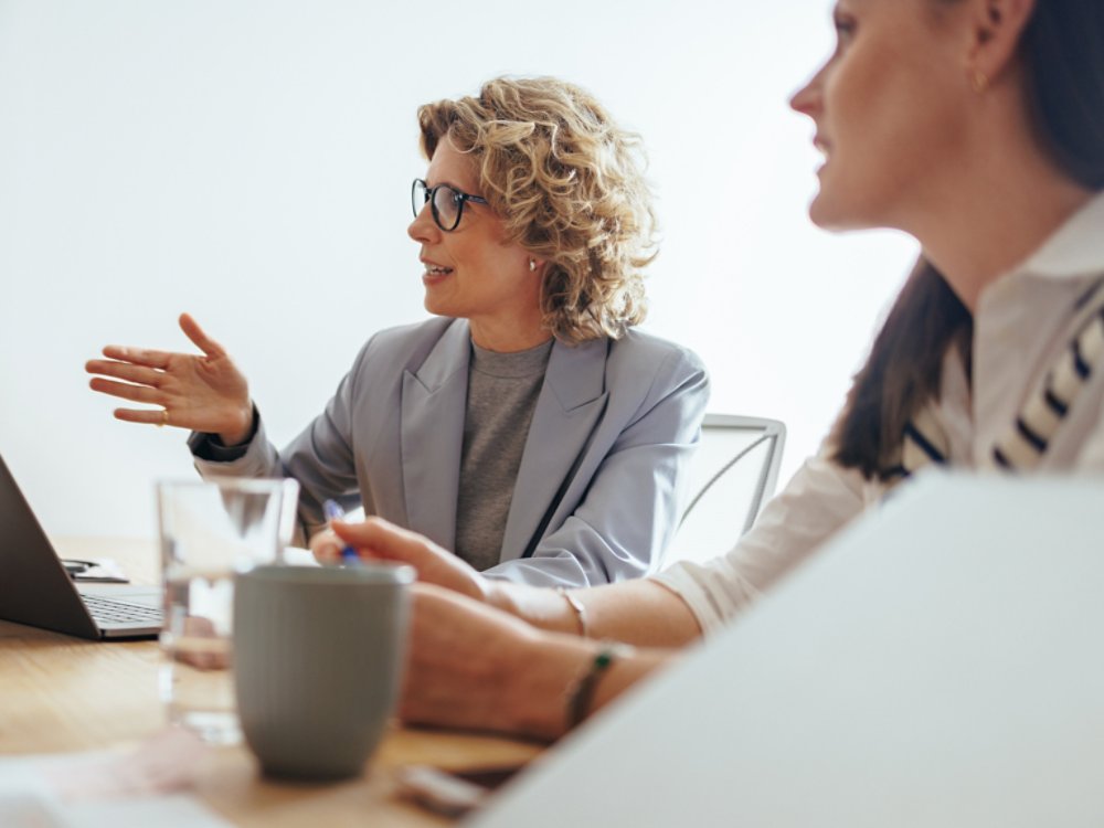 Mature business woman discussing a project with her team in an office