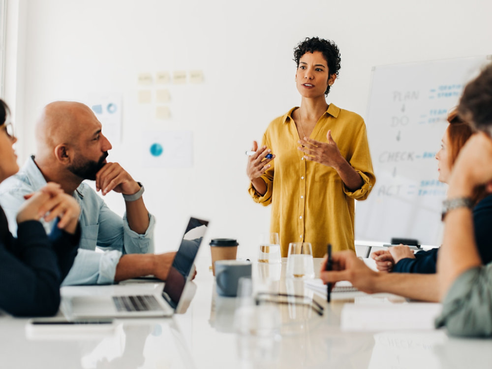 Business woman giving a speech in a boardroom meeting