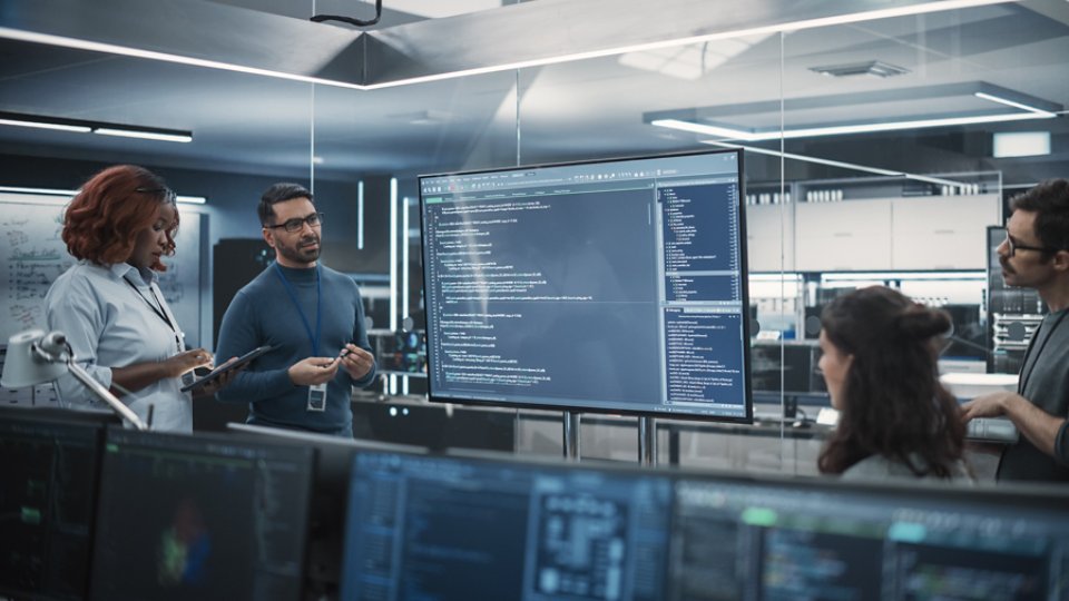 Team of Diverse Software Developers Having a Meeting in Order to Review the Code Done by Computer Engineering Department. Manager Making a Presentation for Project Managers at the Office