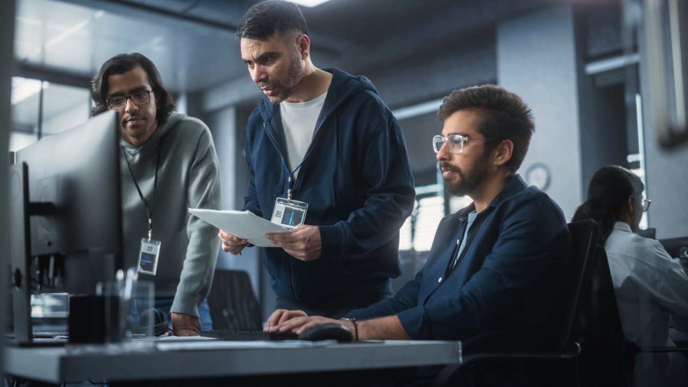 Team of Three Multiethnic Diverse Software Developers Talk, Discuss and Collaborate on an AI Project. Empowered Young Indian Specialists Work on Digital E-Commerce Startup Business