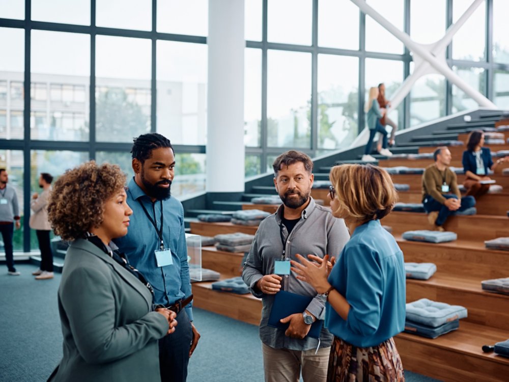 Multiracial group of business people communicating while attending education event at convention center. 