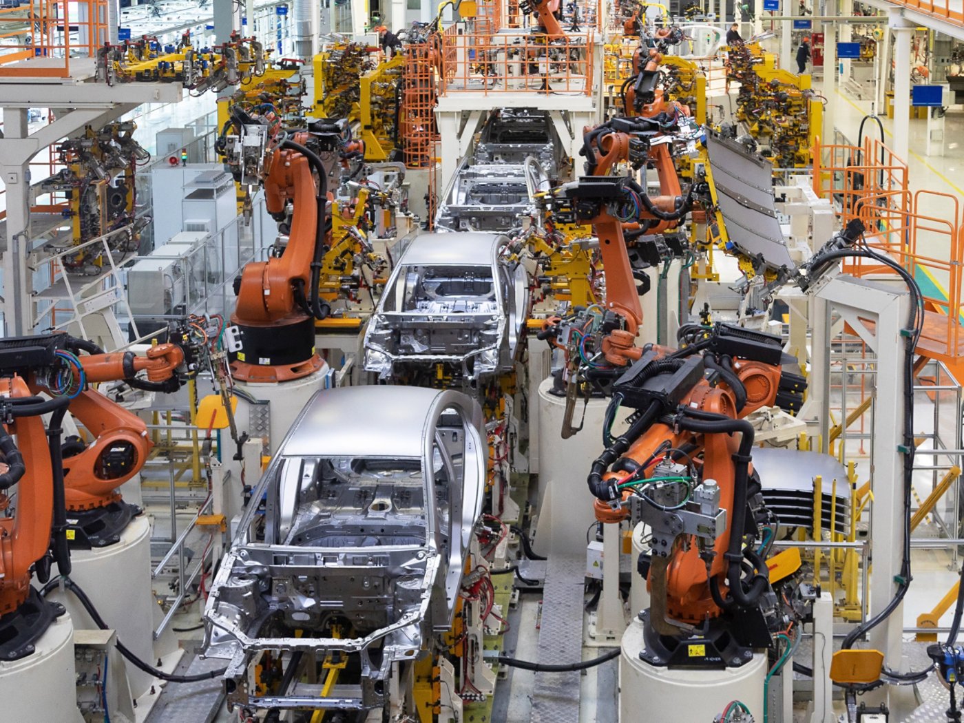 Cars being assembled at a modern automotive plant.