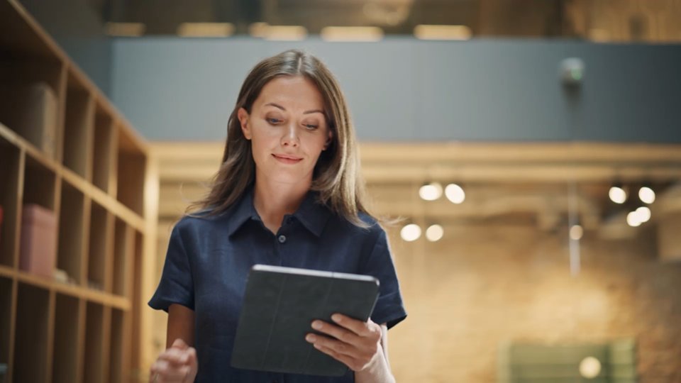 A still image of a lady smiling , exploring data to provide seamless banking expereince to its customers