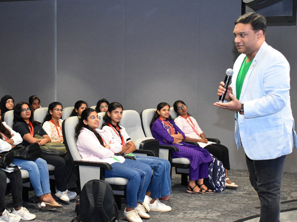 Raj speaking to early graduates