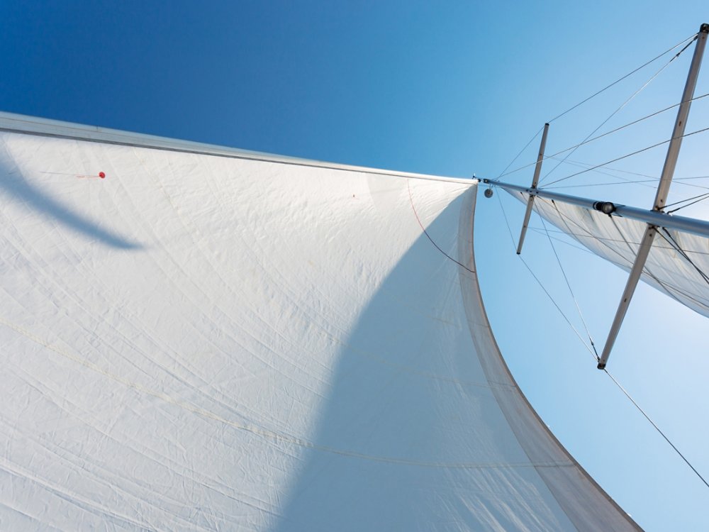 white sails against the blue sky
