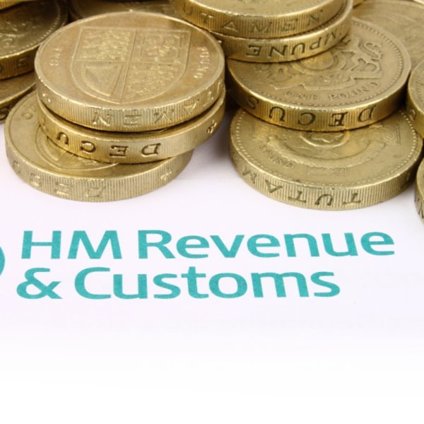 HM Revenue & Customs Tax Return with Pound coins.
