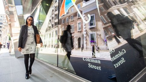 A woman walking past the Legal and General London Office