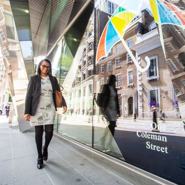 A woman walking past the Legal and General London Office