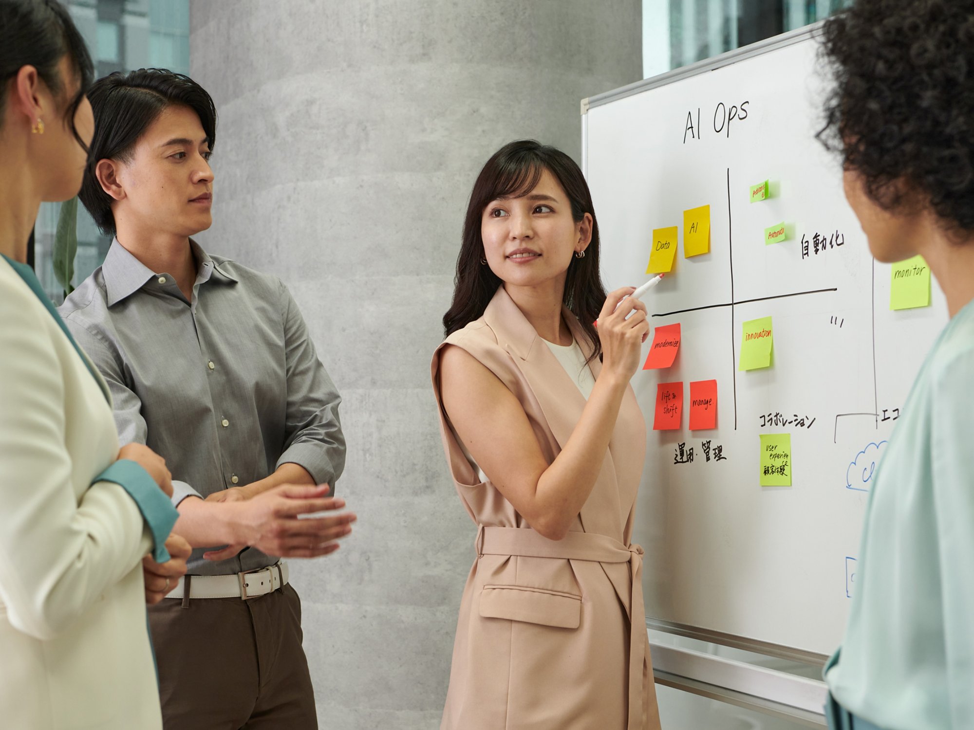 Employees from Kyndryl in Japan working on solutions to a business problem