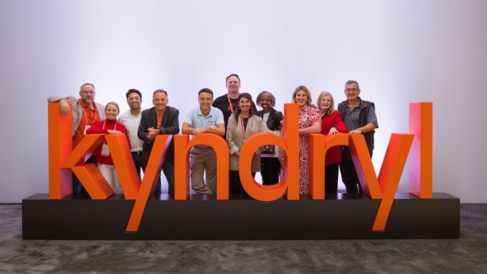 Group photo with Kyndryl signage