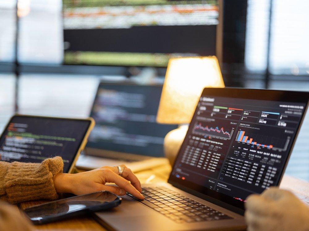 Woman working on some programming dashboard on laptop, close-up on hands and keyboard. Programmer, software tester or analyst working online