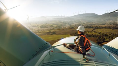 worker on top of wind turbine