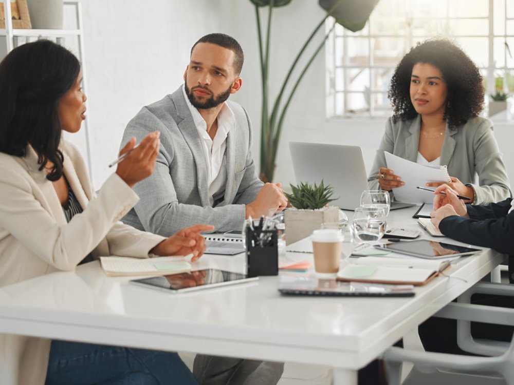 Office, collaboration and business people with discussion in meeting, planning and case review in law firm. Employees, lawyers and team with listening for justice updates, corporate project and ideas.