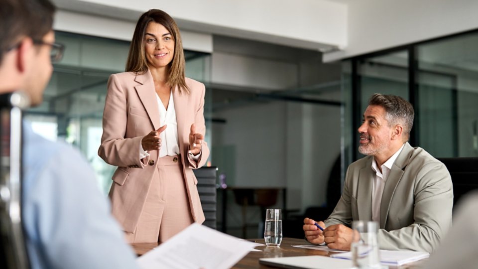Busy mature professional board executive colleagues successful business team people collaborating having corporate teamwork discussion together at group office conference meeting boardroom table.