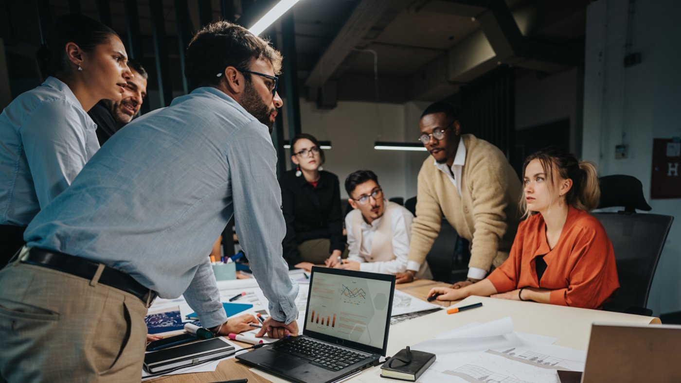 Group of business professionals working together in a modern office setting