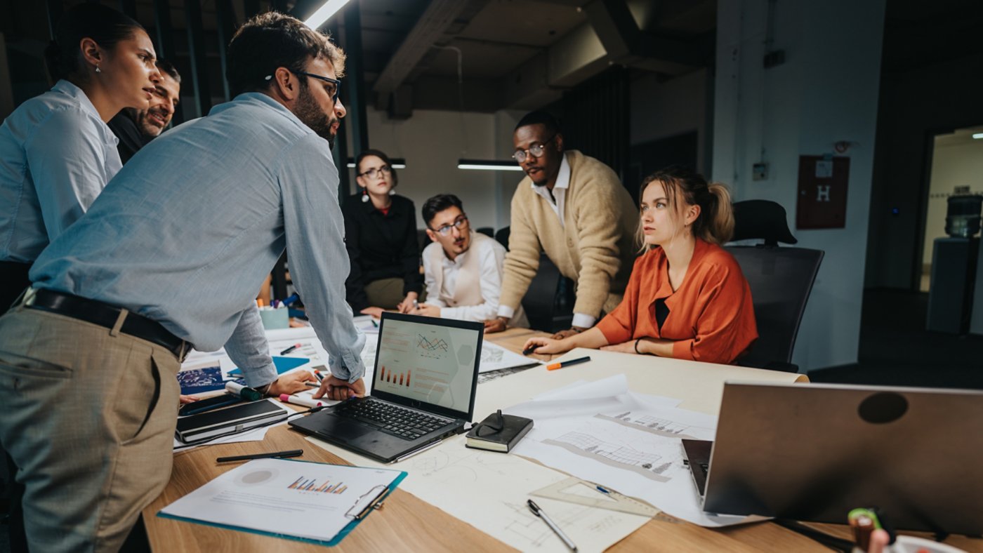 Group of business professionals working together in a modern office setting