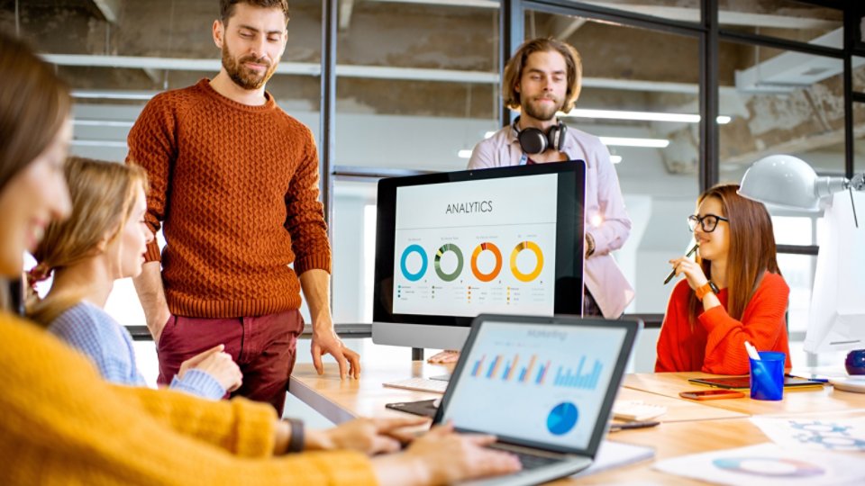 People working together on the computers in the office 16x9
