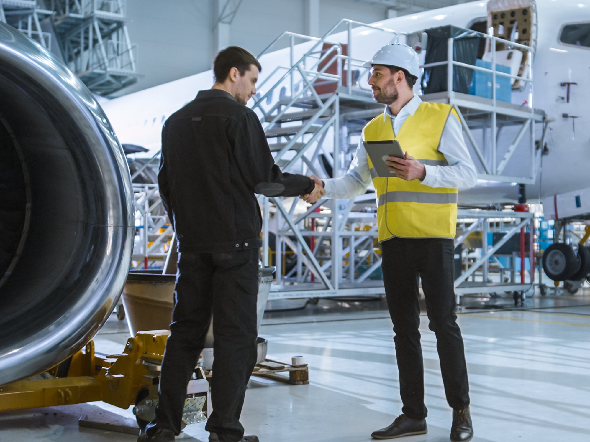 Engineer moving though Aircraft Maintenance Terminal Greeting a Mechanic