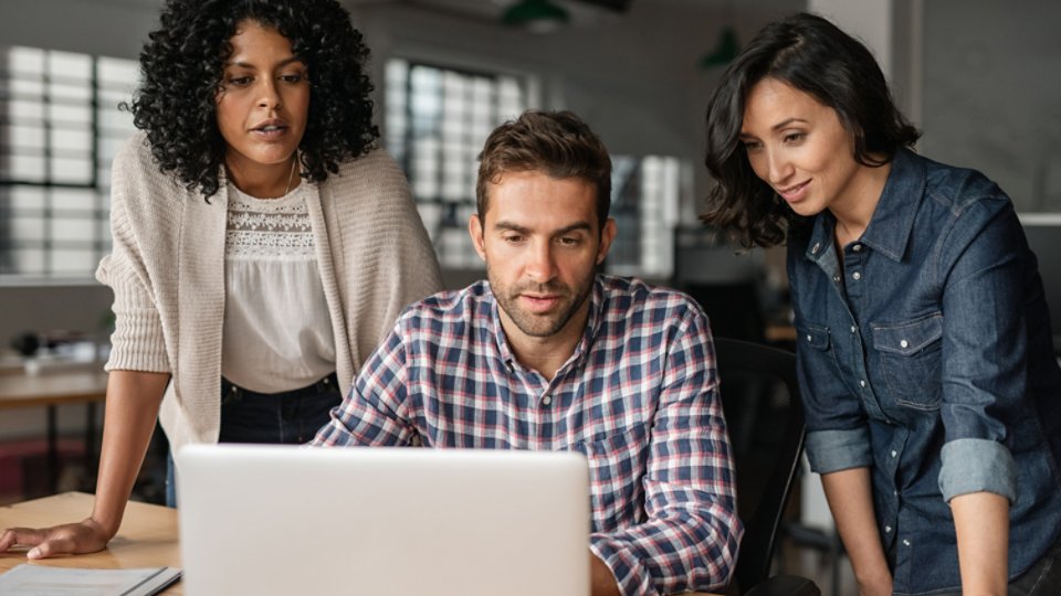Diverse young designers working online with an office laptop - 16x9