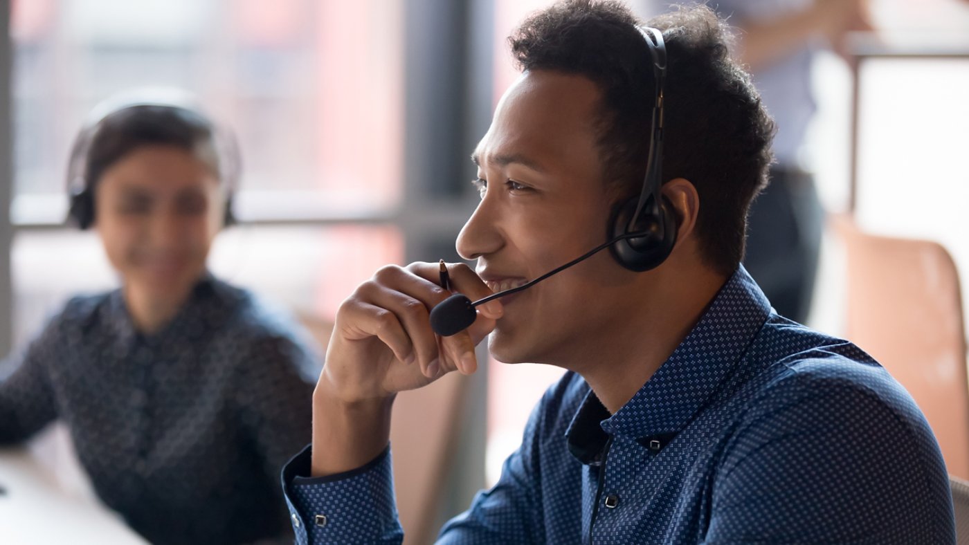 Smiling young asian businessman call center agent laugh at workplace 16x9