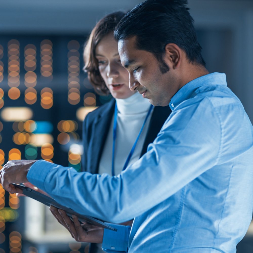 Two computer engineers discussing a report