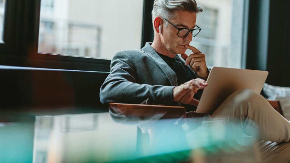 Businessman making project decisions on his computer