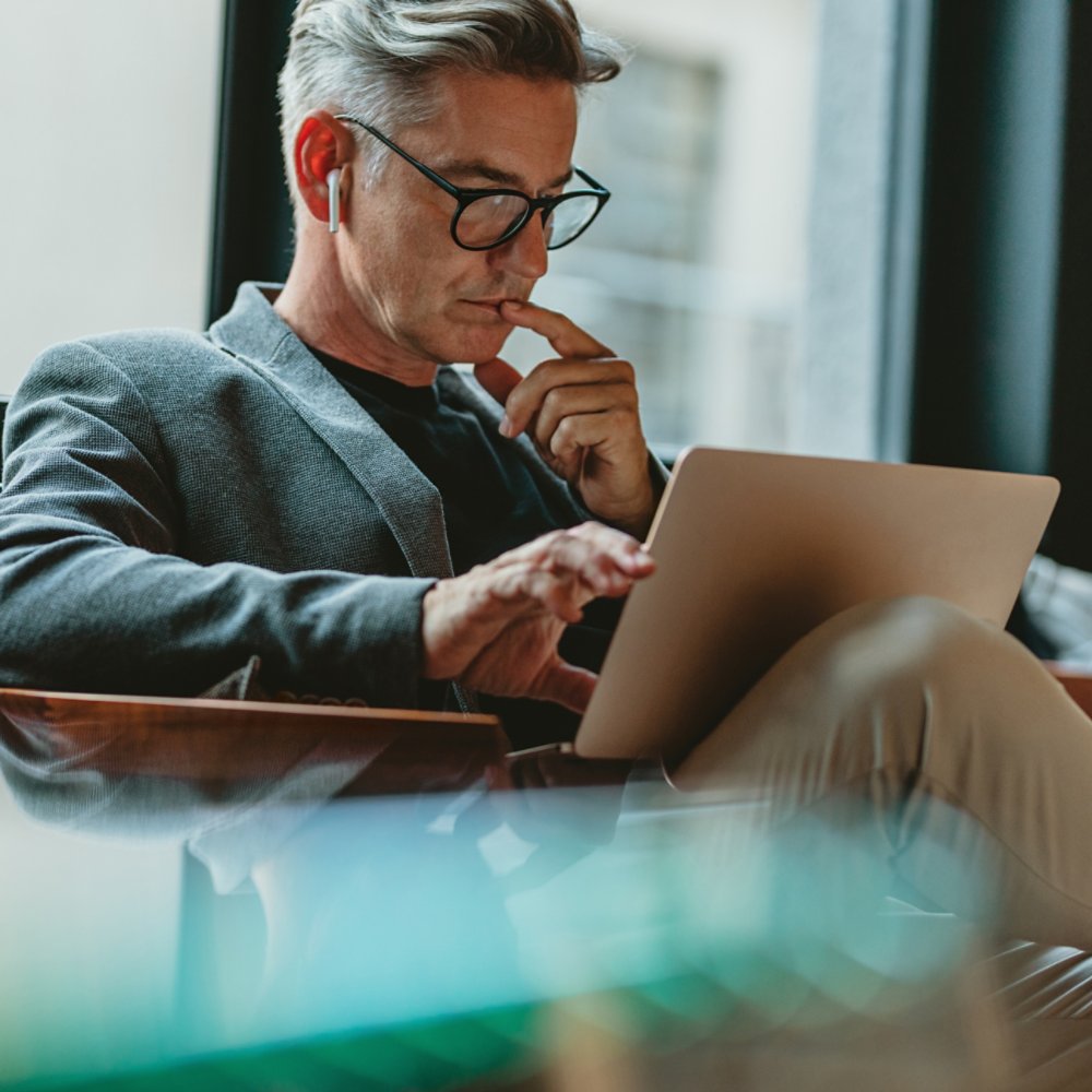 Businessman making project decisions on his computer