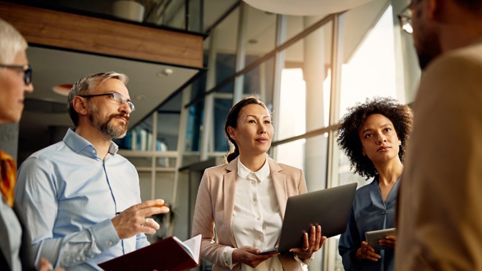 people working on a business project and listening to a presentation