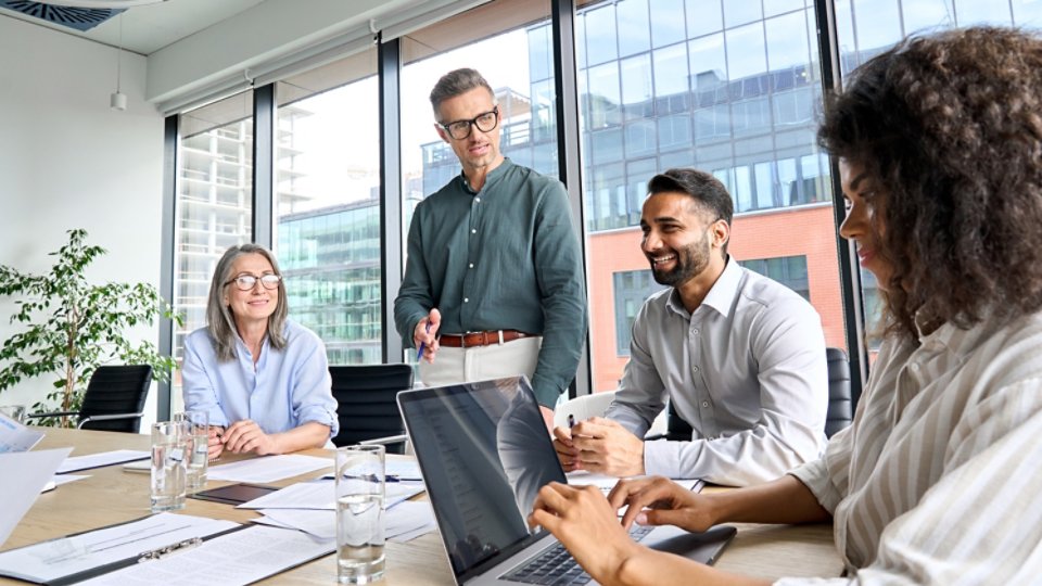 Four people working in a conference room