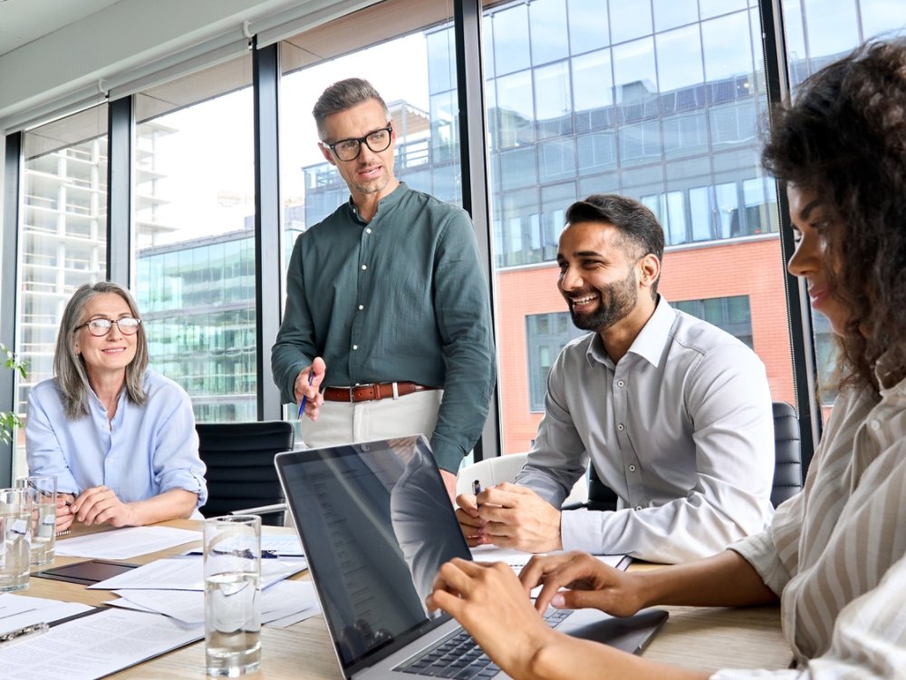 Four people working in a conference room