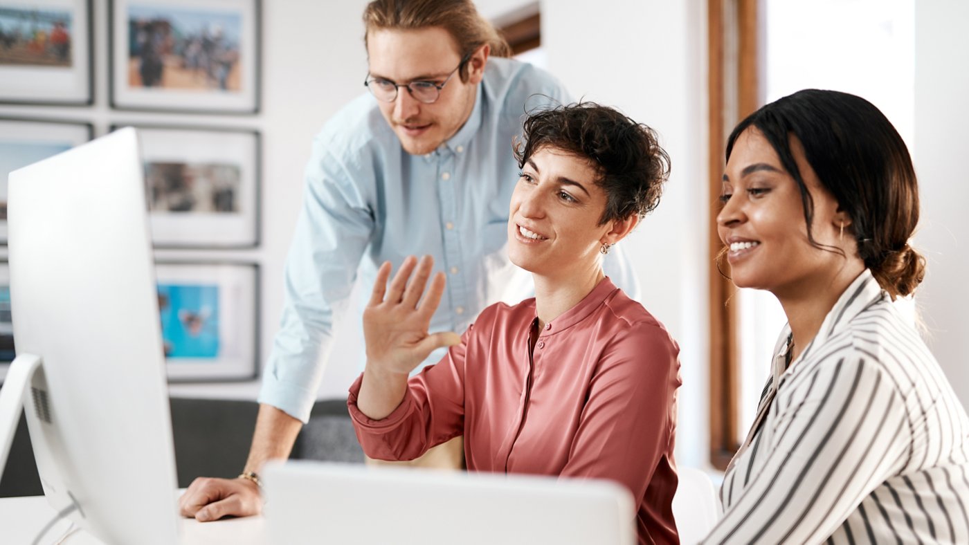 Small company with big ambitions. a diverse group of businesspeople working on a computer together during a meeting in the office.