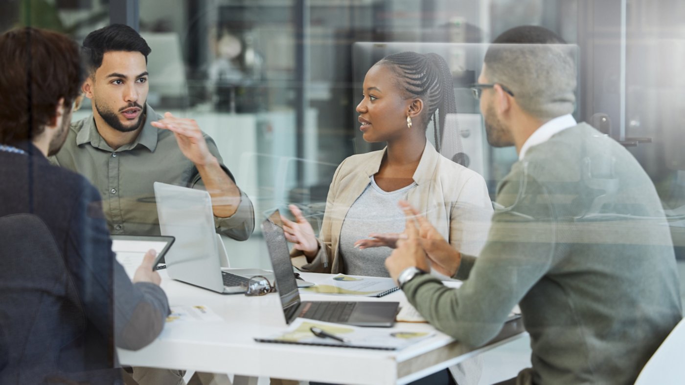 Meeting, collaboration and business people in discussion in the office while working together. Teamwork, planning and group of employees brainstorming with technology for a project in the workplace.