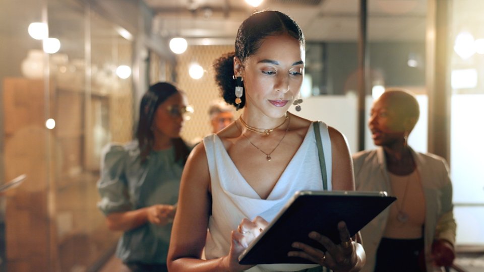 Tablet, team and black woman in office walking to business meeting doing research, online and using internet. Teamwork, leadership and group of busy female workers together in corporate workplace